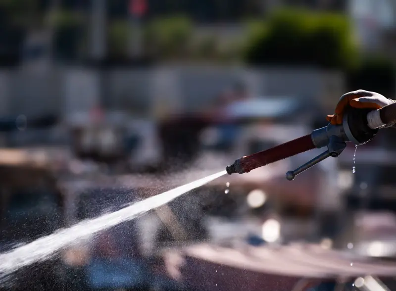 High-pressure water jet spraying from a nozzle.